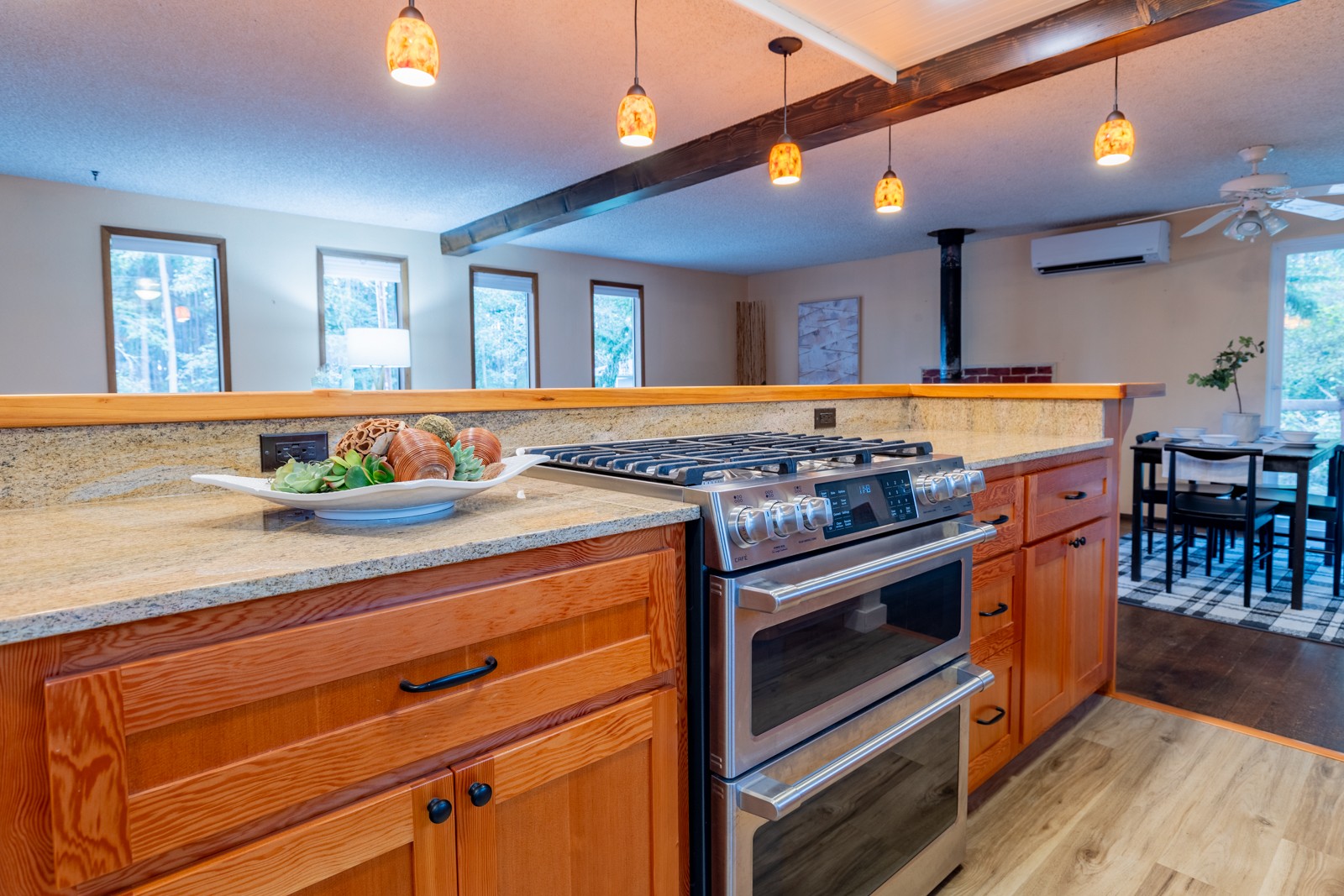 Kitchen cabinetry detail with granite countertops and pendant lighting